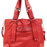 Bolso tote Patsy de piel roja con logo de tachuelas
