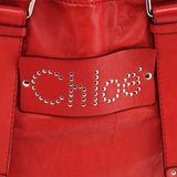 Bolso tote Patsy de piel roja con logo de tachuelas