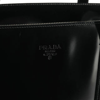 Embossed Prada Milano logo on black Spazzolato patent leather