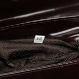 Prada Sac à poignée Spazzolato logo en cuir verni marron